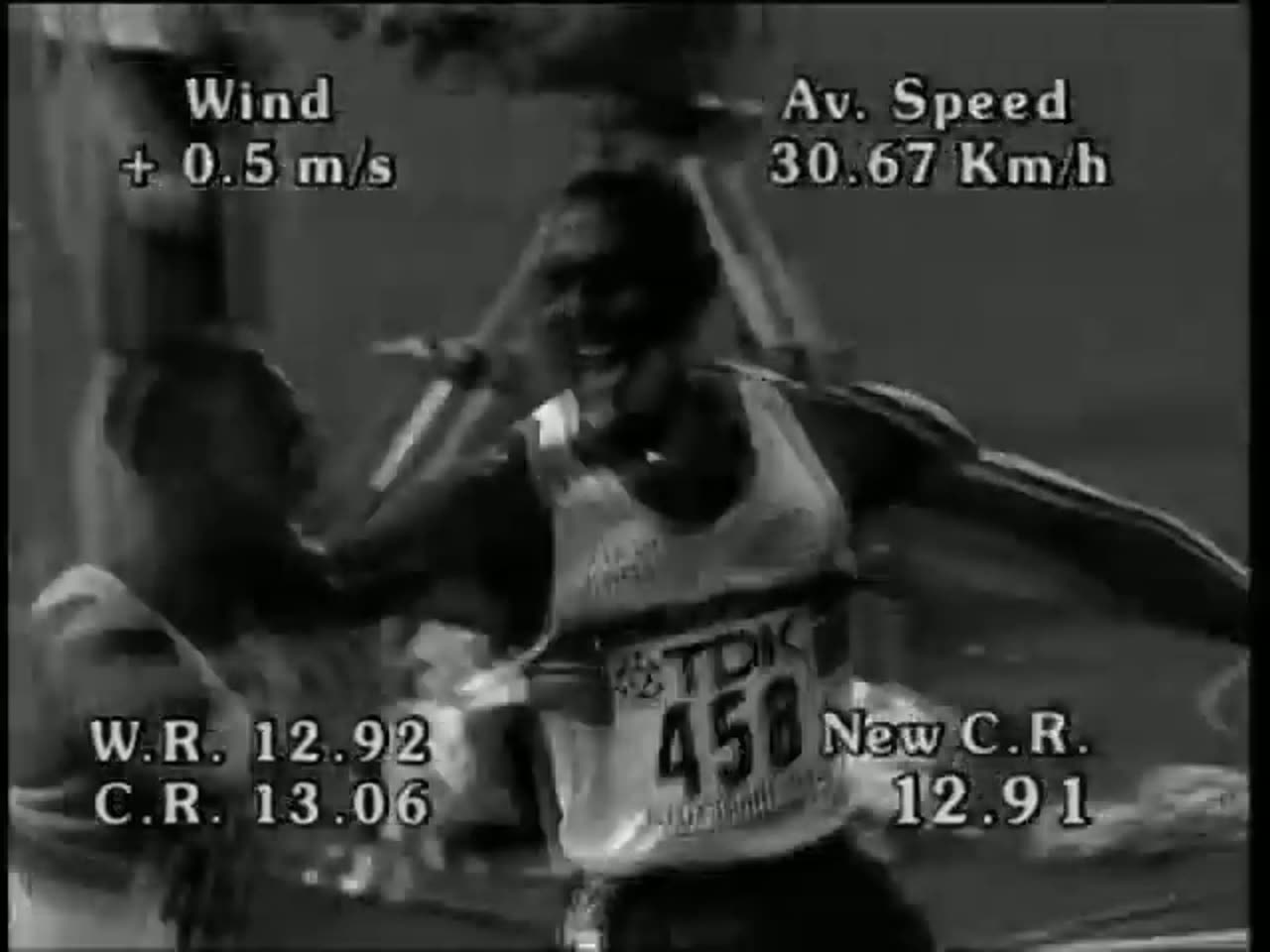 Colin Jackson CBE in a black shirt, arms folded, smiling